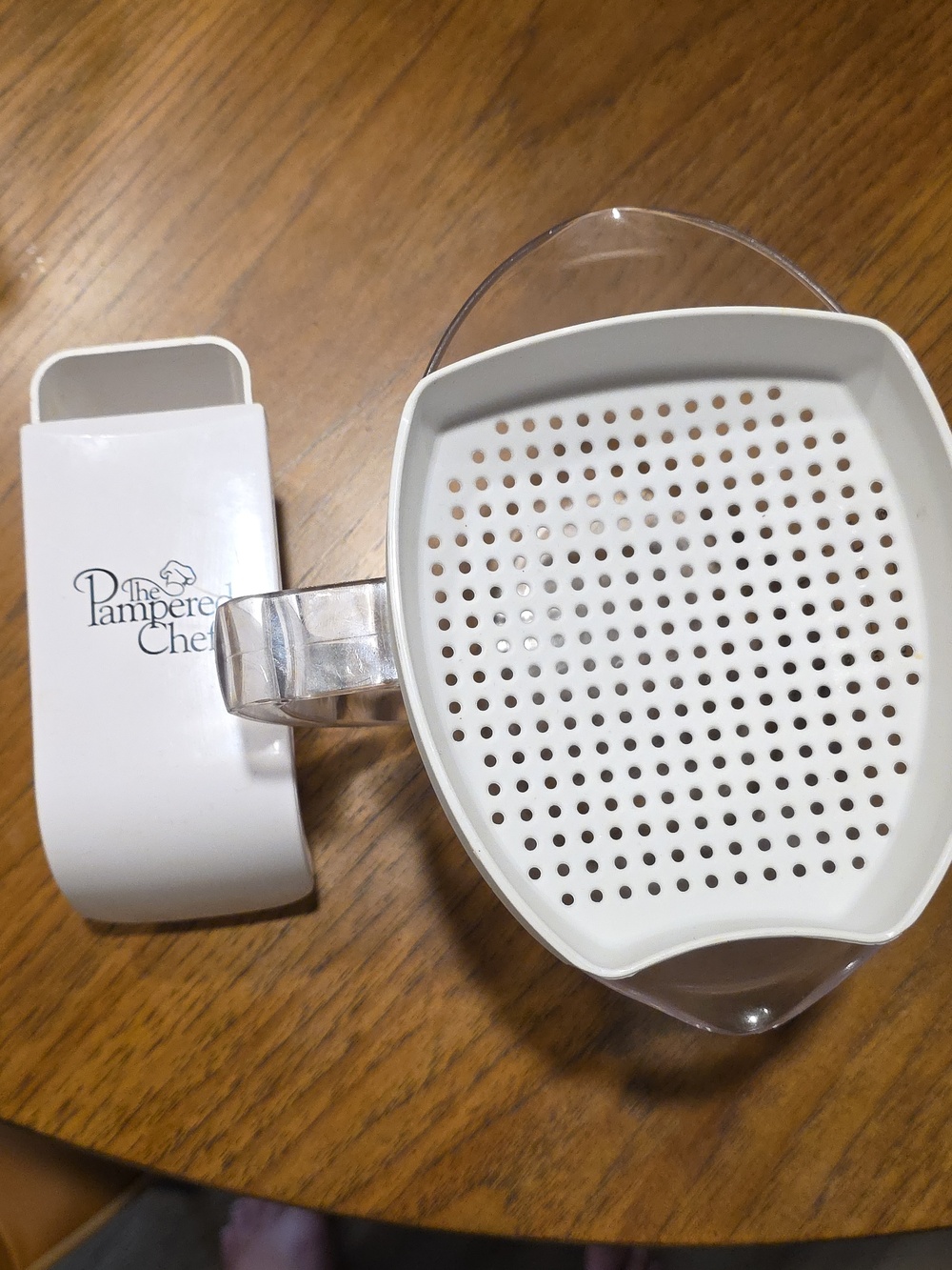 The Pampered Chef White Plastic Measuring Bowl with Strainer Insert.